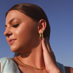 Burdlife Model wearing 3 earrings including the Luxe Oval Hoops, the Refined Single Chain Earring and the Modish Triple Crystal Studs. 