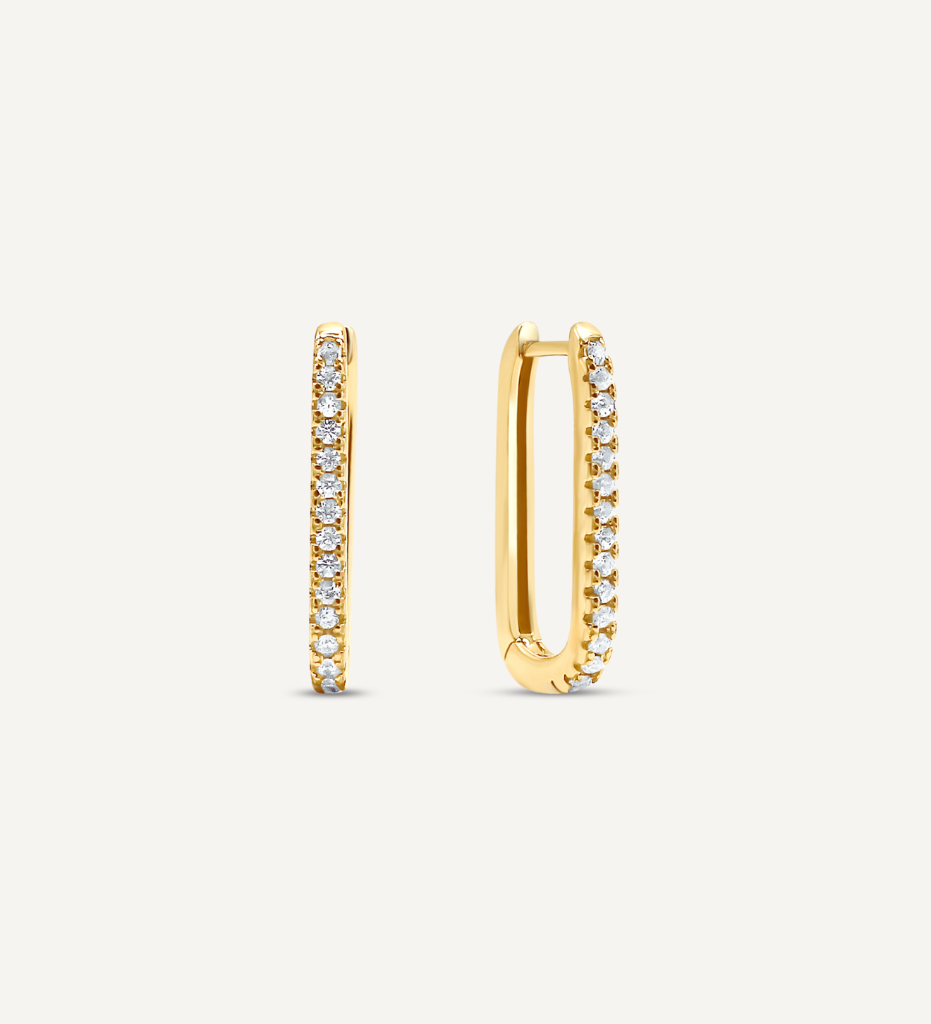 18K Gold Filled oval shaped hoops that click close with a latch and are studded with small, round clear Cubic Zirconia crystals.