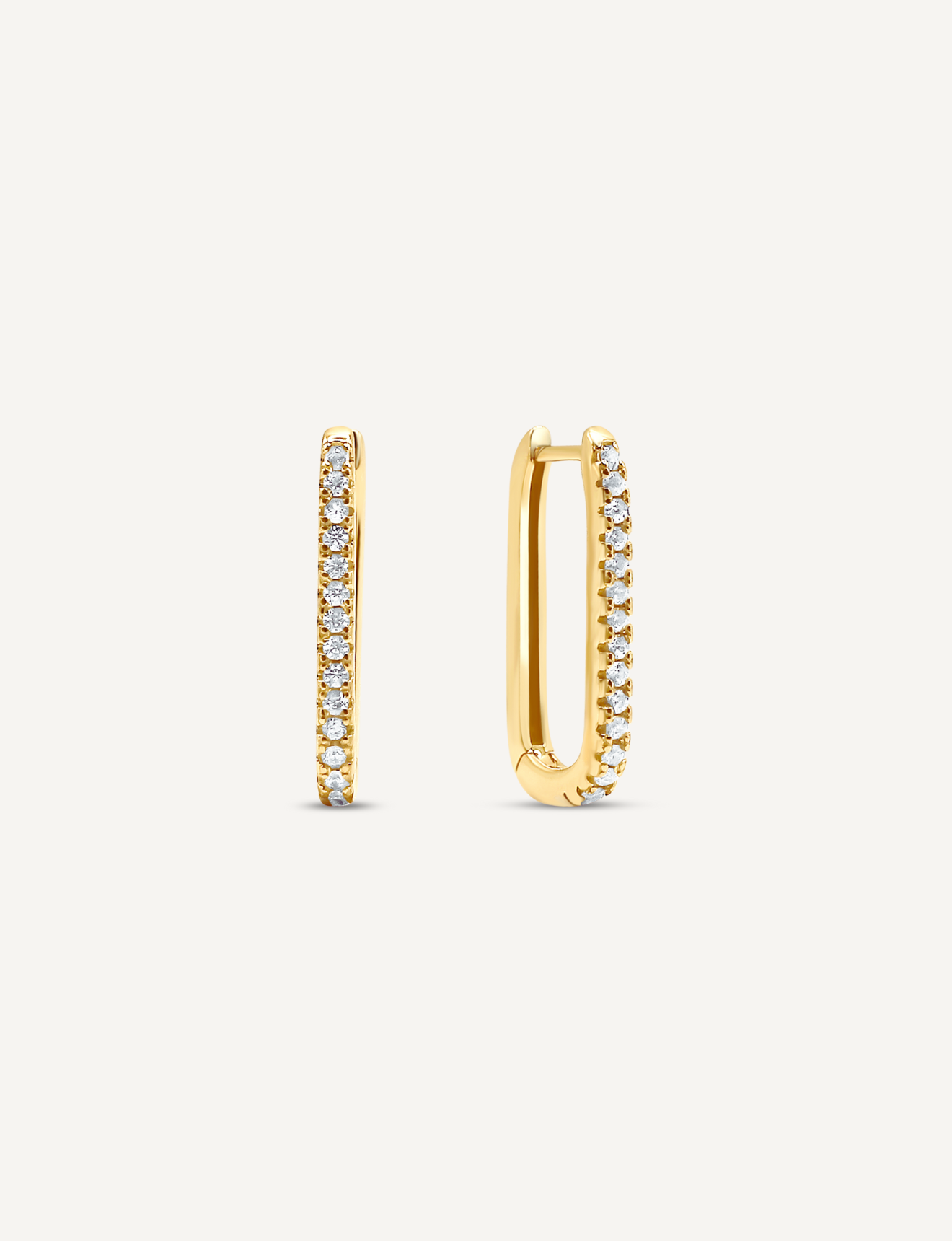 18K Gold Filled oval shaped hoops that click close with a latch and are studded with small, round clear Cubic Zirconia crystals.