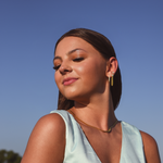 Model wearing 3 earrings including the Luxe Oval Hoops, the Refined Single Chain Earring and the Modish Triple Crystal Studs. 